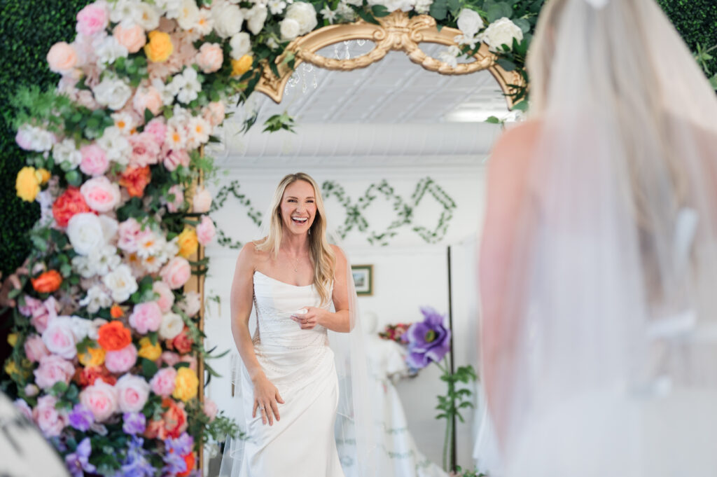 bride saying yes to her wedding dress at bride of the pines in aberdeen nc looking in the mirror