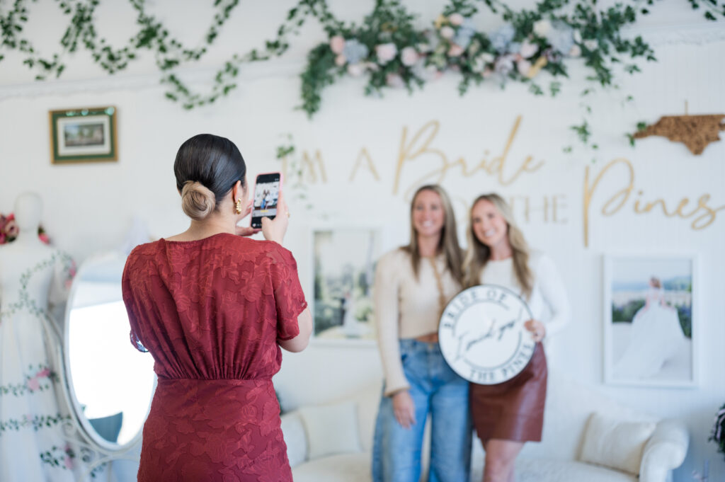 Bride taking yes photo after finding dream wedding dress at bride of the pines,
taylor lawrence bridal, fayetteville bridal store