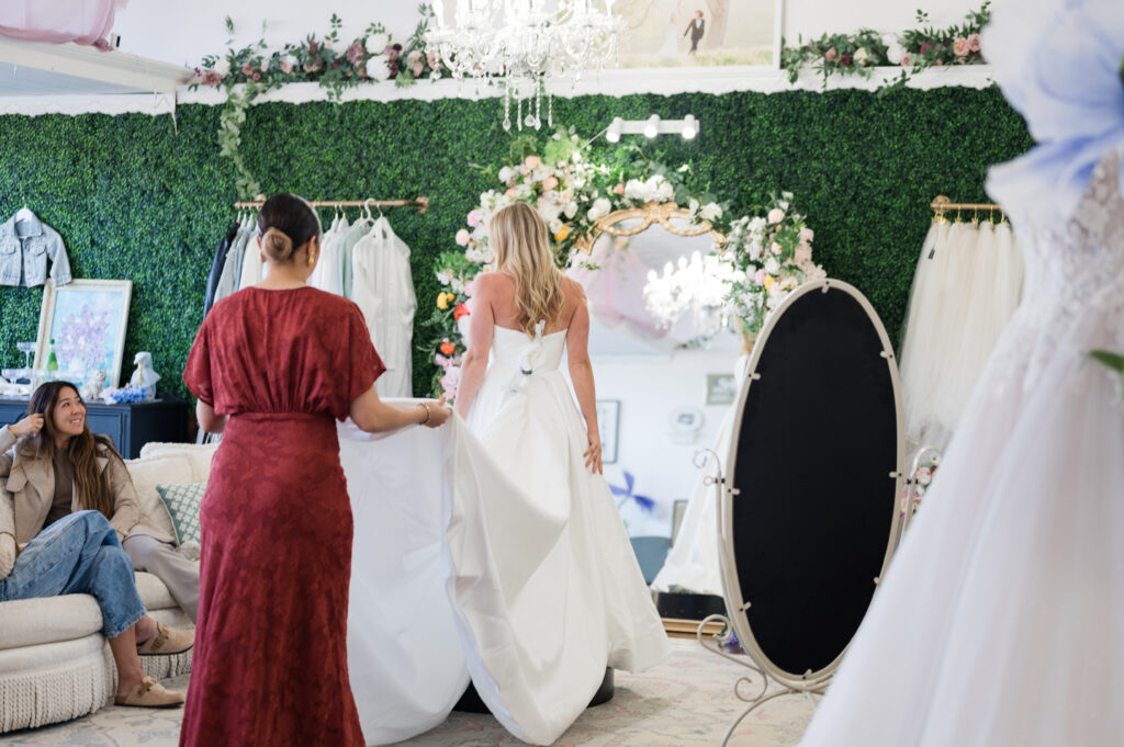 Bride walking to mirror in wedding gown at bride of the pines a bridal shop located in aberdeen cn and southern pines nc